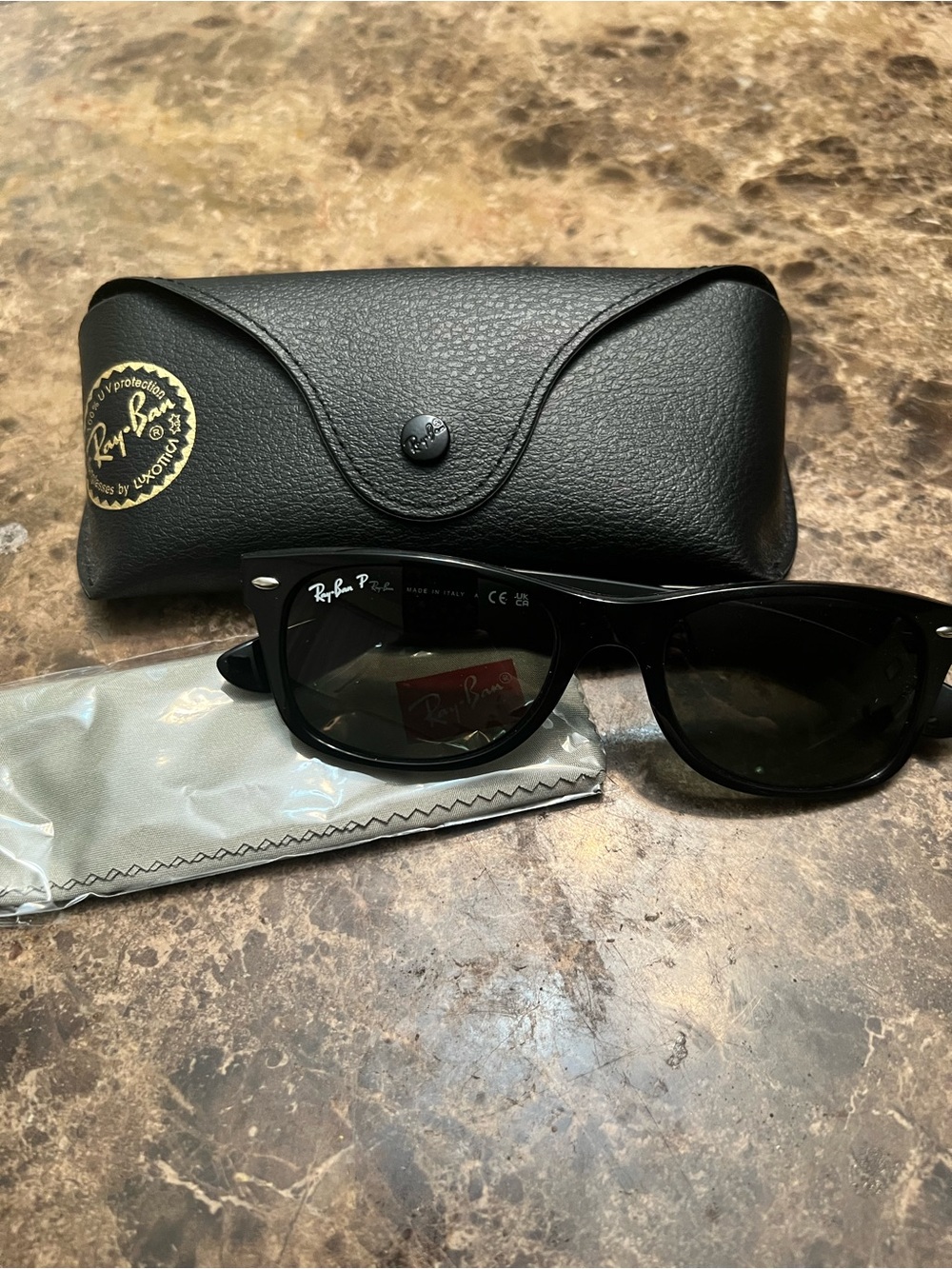 Ray-Ban New Wayfarer Black Frame with polarized lenses.